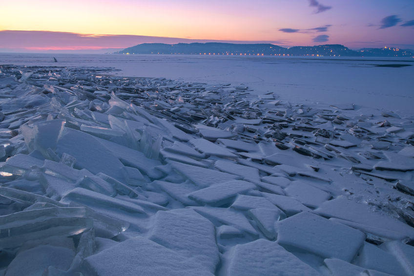 52068372 - winter landscape with frozen lake balaton and sunset sky in hungary